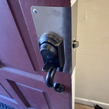 Entry deadbolt and handle hardware being repaired