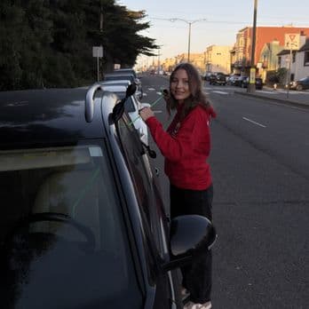 Customer by a vehicle after roadside locksmith help