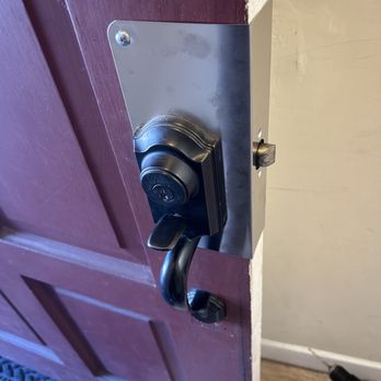 Entry deadbolt and handle hardware being repaired